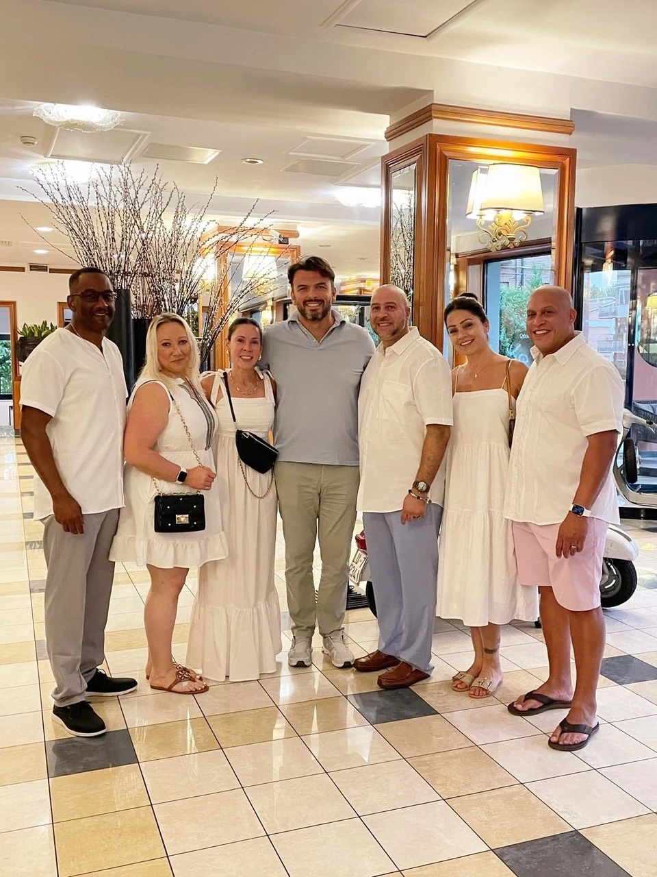 Sasha Rojnik and guests together in a hotel lobby