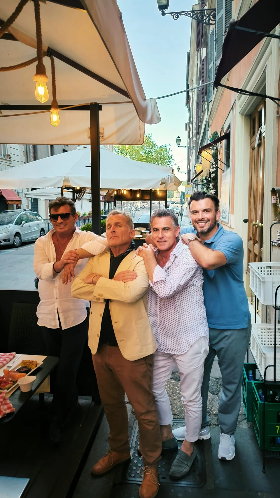 Sasha Rojnik with three guests outside a street café