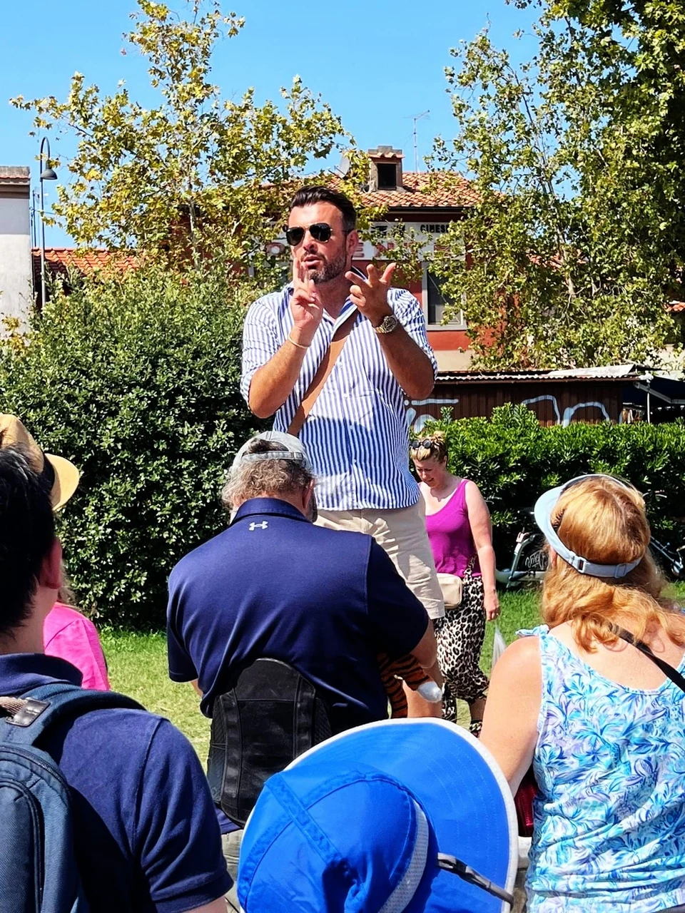 Sasha Rojnik sharing a story with his tour group outdoors